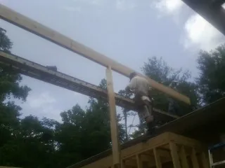 Carpenter setting a ridge beam over a new addition frame — Ice Dam Removal by Roofing Brothers in Prairie Du Sac